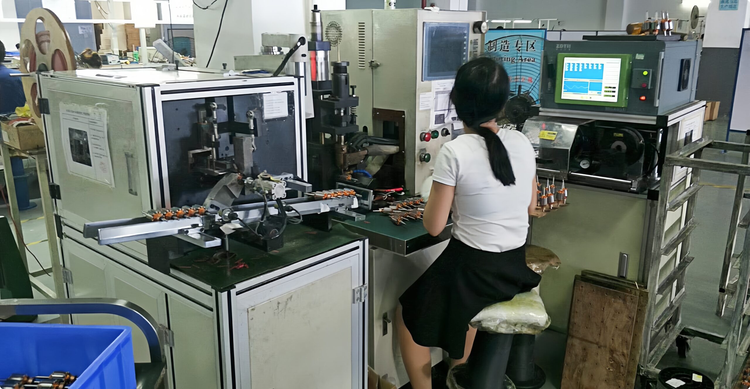 Technician operating DC motor assembly machine at Ruito facility